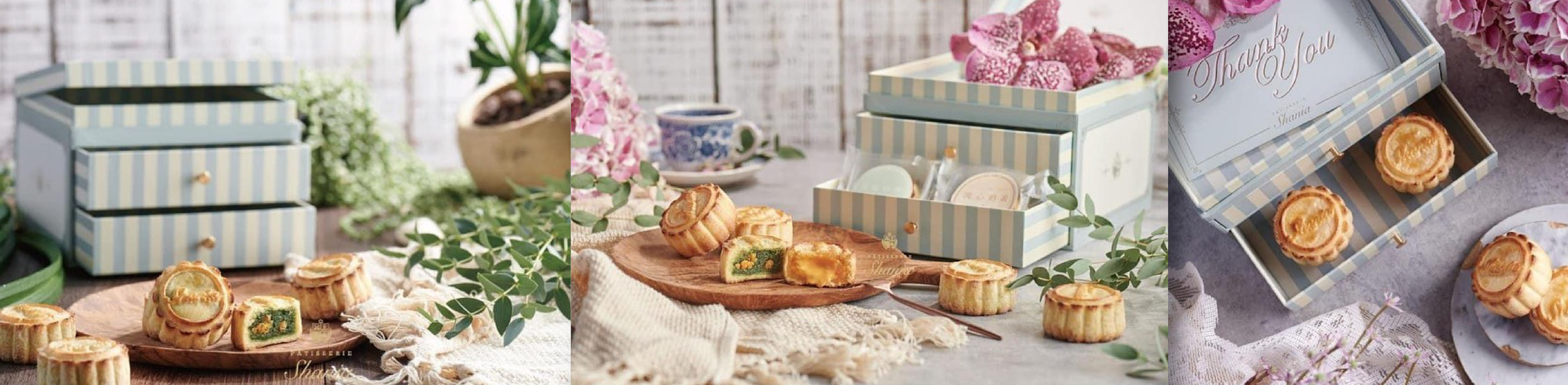一系列PÂTISSERIE品牌的糕點包裝盒，呈現藍色和白色條紋設計，盒子上有“Thank You”字樣，旁邊擺放著糕點和茶點，整體場景營造出感謝與慶祝的氛圍