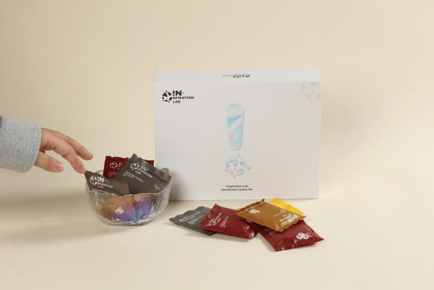 a hand is taking the cookies and Magnetic Book-Shaped Rigid Box