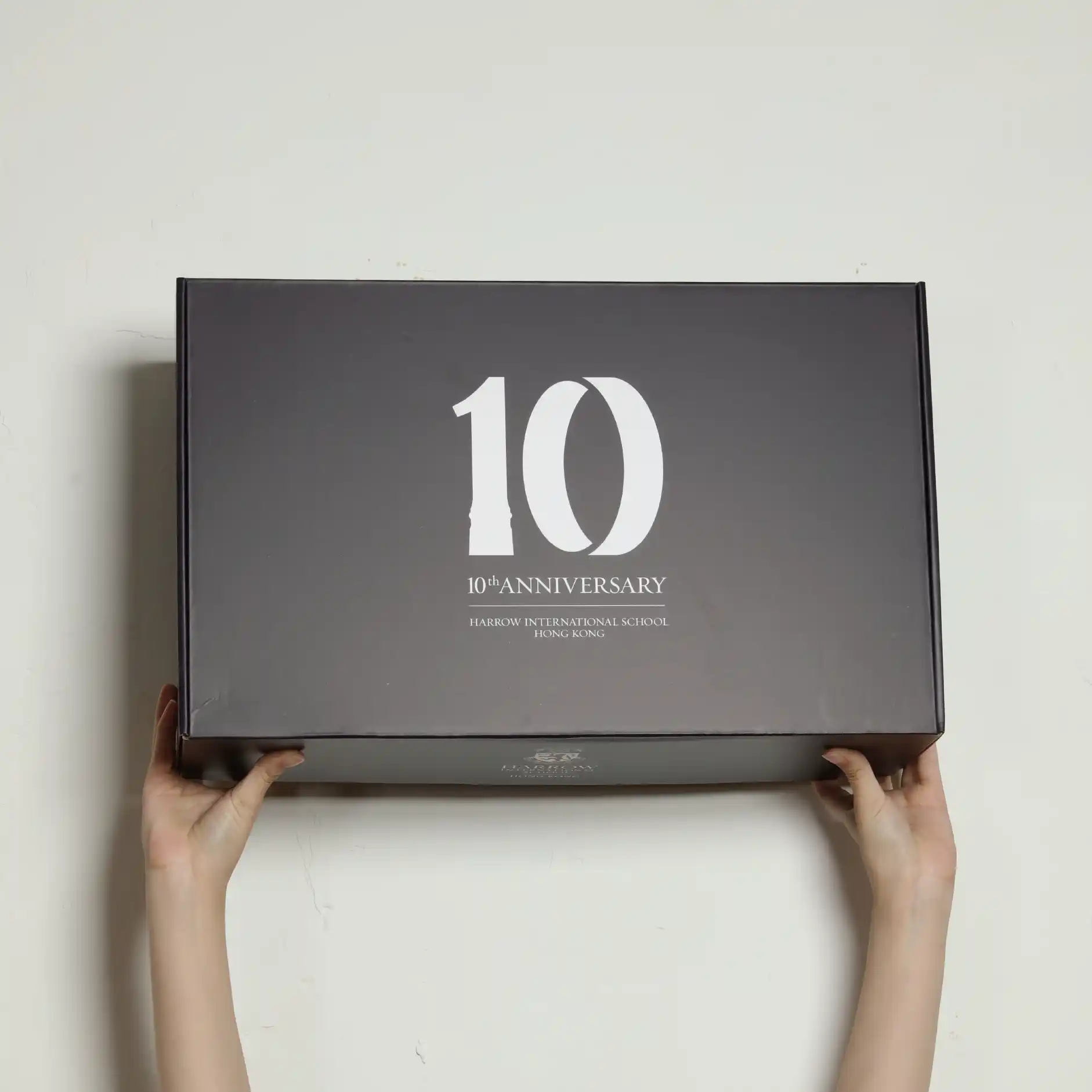 two hands are holding the full color mailing box