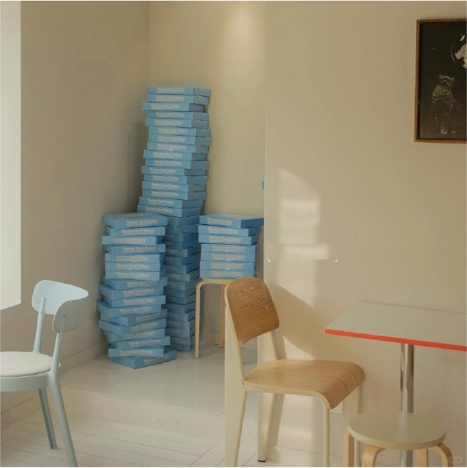 Stacked blue customised boxes in the bakery show the simplicity of professional packaging design.