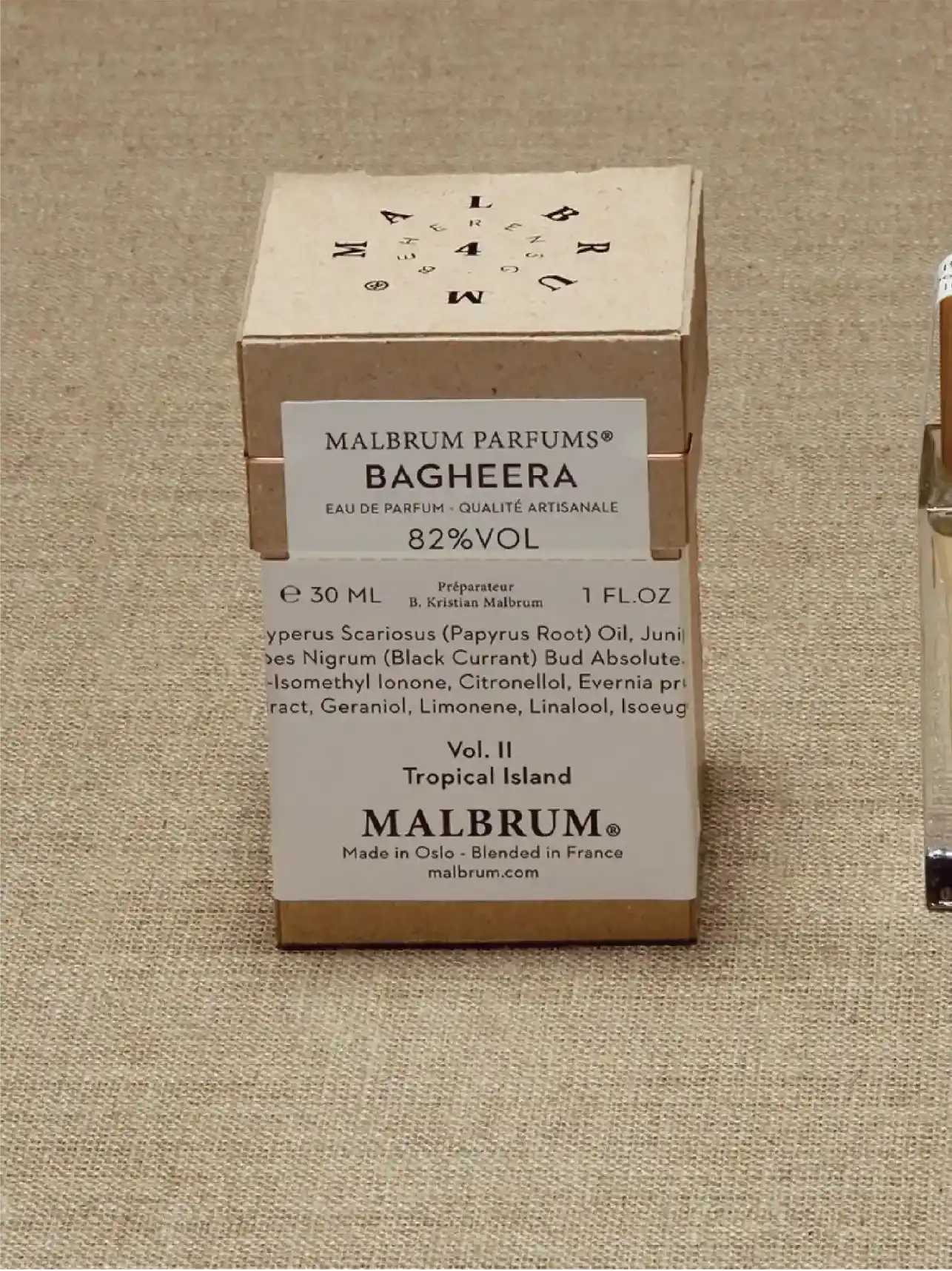 A closed perfume box is placed upright on a light-coloured background with the brand name 'MALBRUM PARFUMS' and the name of the perfume 'BAGHEERA' as well as other product information.