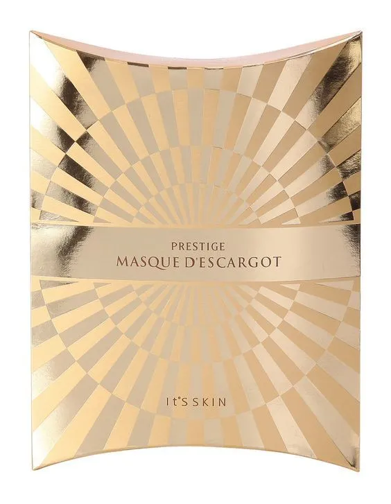 A glossy gold packaging with a radiating pattern and the words "PRESTIGE MASQUE D'ESCARGOT", which shows the luxury and professionalism of the product.
