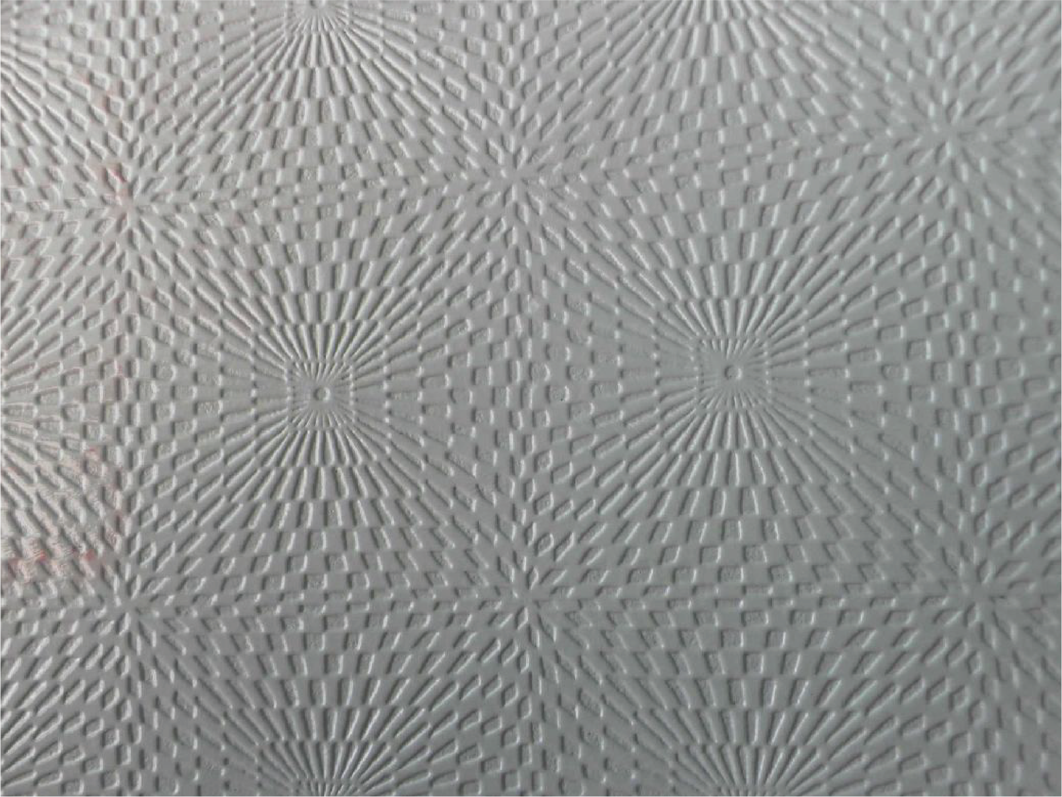 The image shows a surface with a bumpy texture consisting of a series of small rectangles arranged in a concentrated pattern, forming a radioactive sunflower-like pattern.