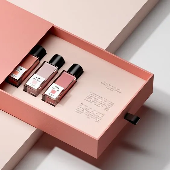 A cosmetic nail polish set in a pink gift box, featuring delicate branding and an elegant, detailed design that highlights the quality of the brand.