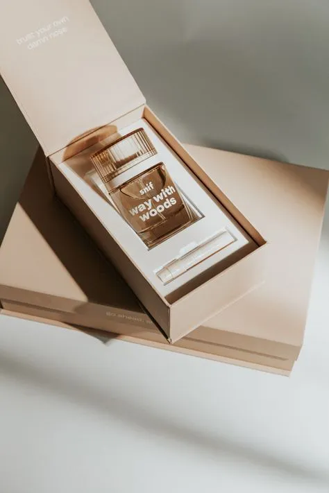 A bottle of perfume in a light brown cosmetic box under the sun, revealing a natural and sophisticated aesthetic.