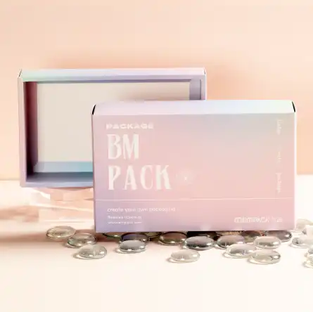 Pink coloured BM PACK box with the brand's transparent embossed effect text printed on the front of the box. The background is pink in colour and the bottom is scattered with small transparent glass discs.